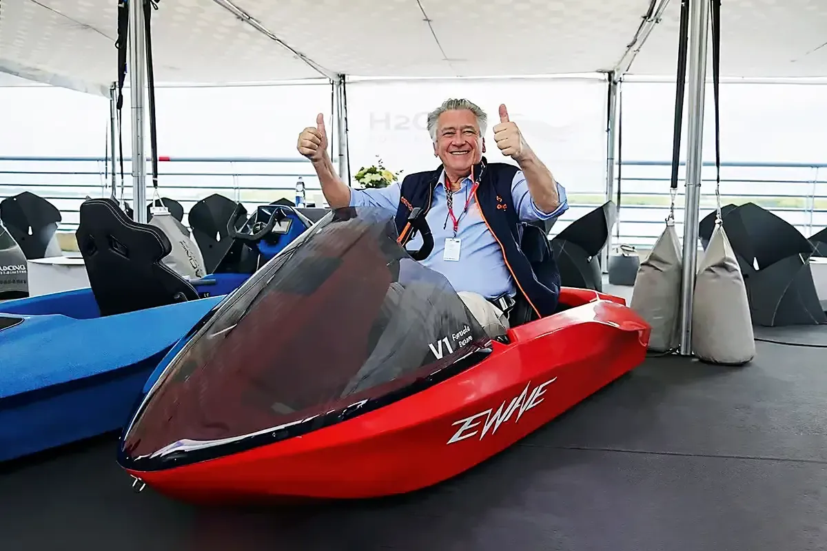 Nicolò di San Germano, founder of H2O Racing, sitting in a red EWAVE V1 and giving two thumbs up